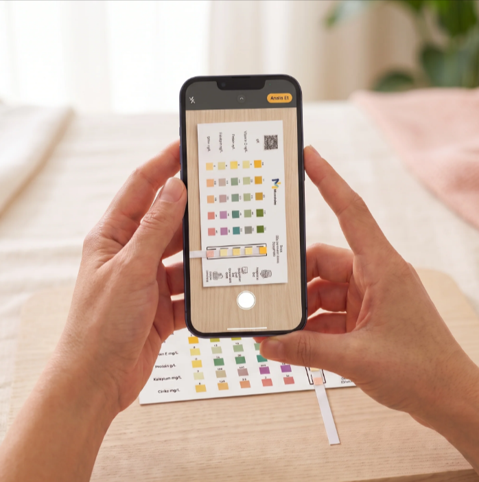 A phone taking a photo of the test strip against the color reference card